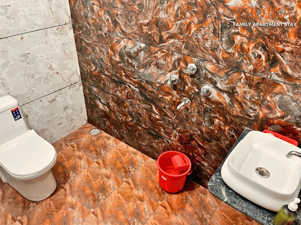 Floor 1 Clean Washroom & Toilet with red/brown marble tiles